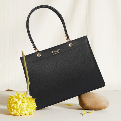 Black handbag with gold accents on a light background