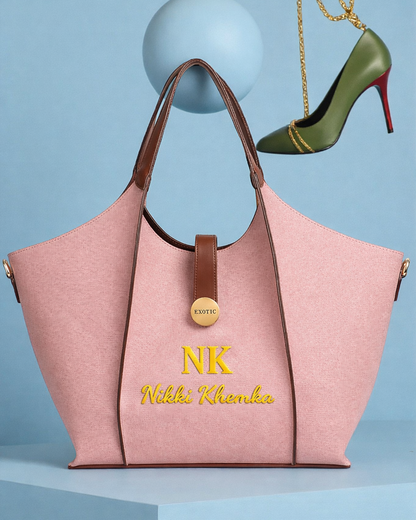Pink handbag with brown handles and gold accents on a blue background