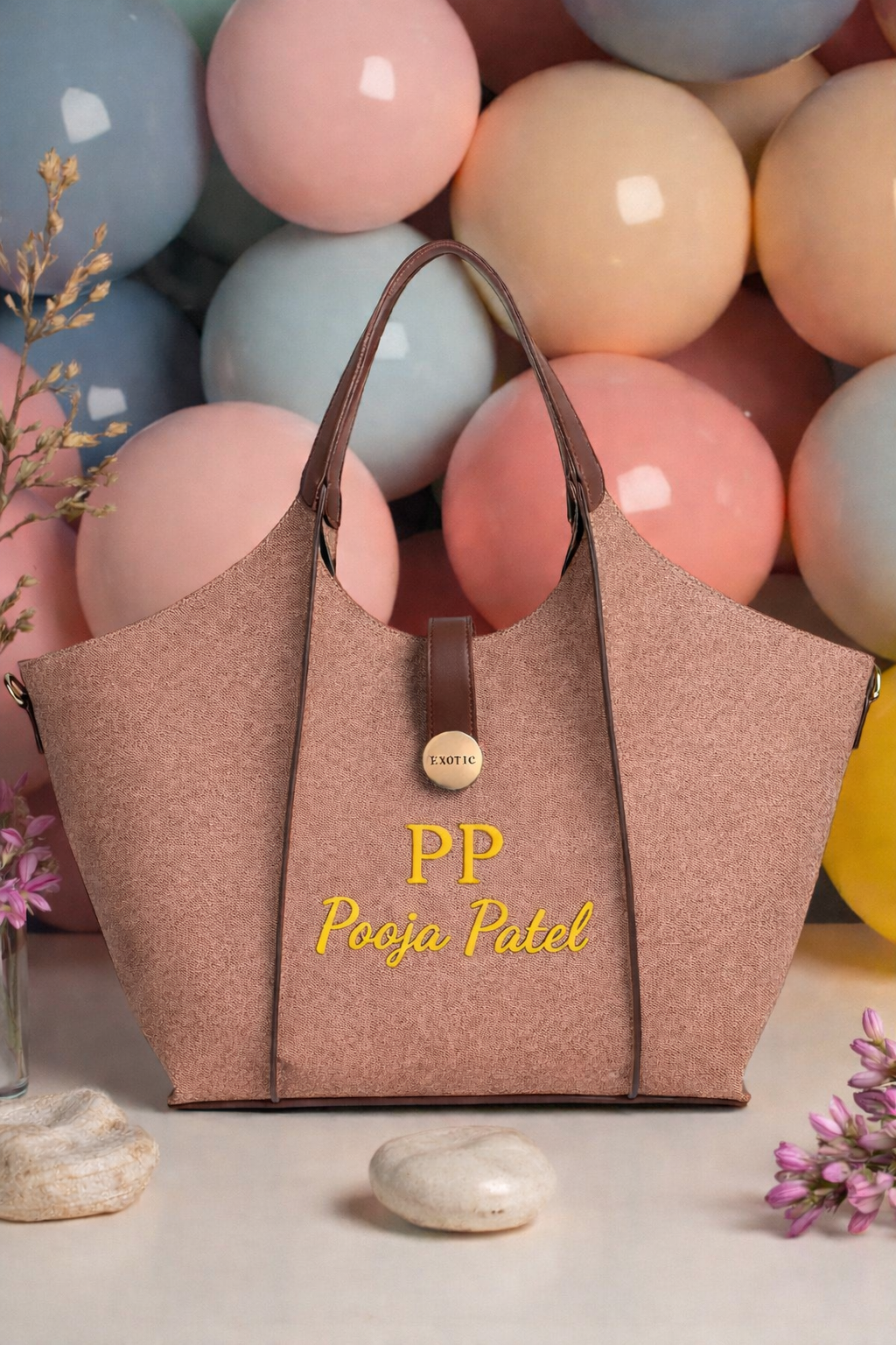 Brown handbag with 'PP' and 'Pooja Patel' branding against a colorful balloon background.