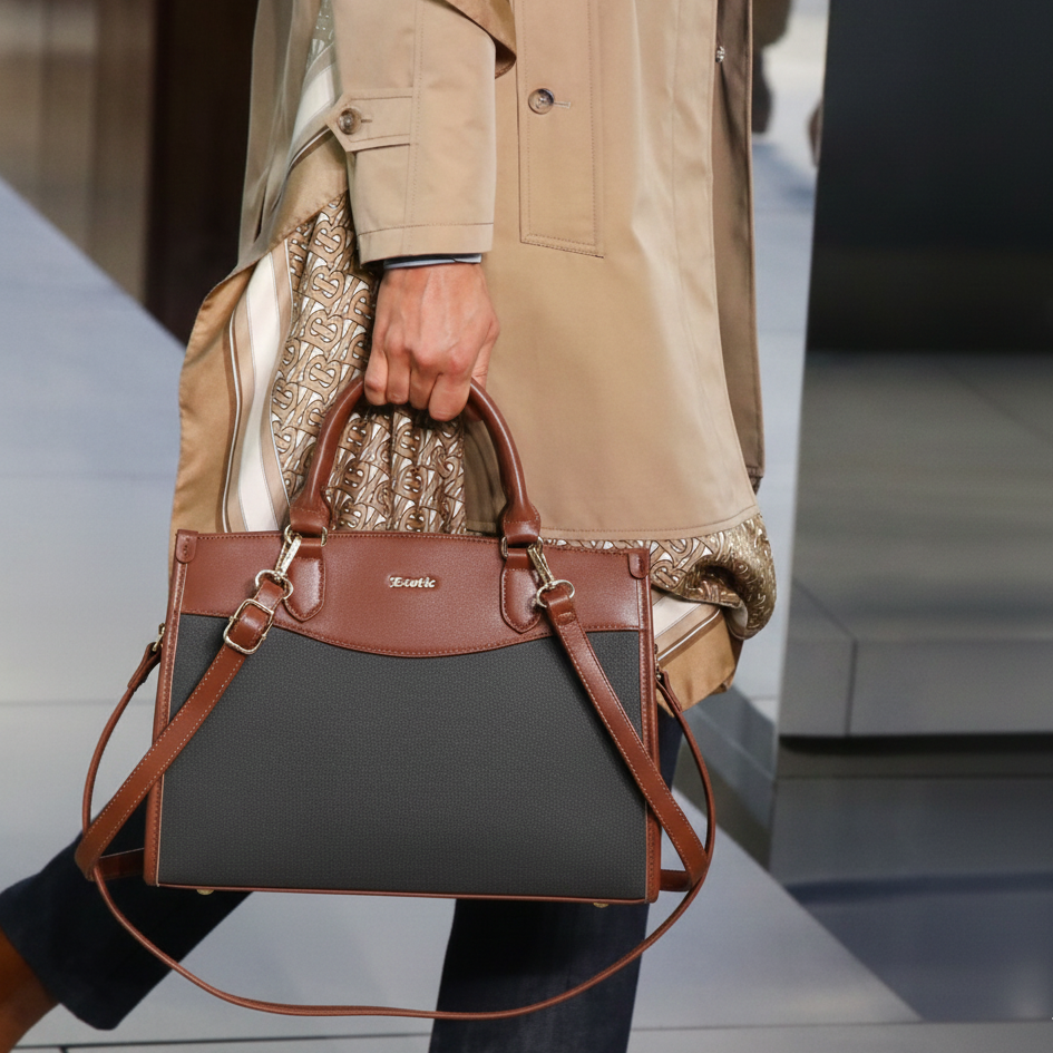 Person holding a two-tone handbag with a blurred background